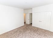 Thumbnail 38 of 45 - a bedroom with white walls and carpet and a closet at The Vines at Riverpark, LLC, California, 93036