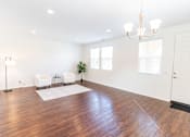 Thumbnail 30 of 45 - a living room with a hard wood floor and white walls at The Vines at Riverpark, LLC, California, 93036