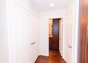 Thumbnail 32 of 45 - the hallway of a home with white walls and wood floors at The Vines at Riverpark, LLC, California, 93036