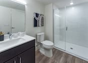 Thumbnail 78 of 78 - A bathroom with a toilet, sink, and shower.