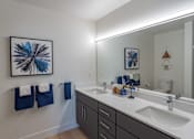 Thumbnail 76 of 78 - A bathroom with a white sink and a large mirror.