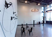 Thumbnail 53 of 78 - A room with a white wall and a row of black chairs.
