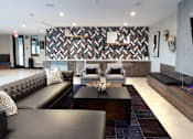 Thumbnail 49 of 78 - A modern living room with a black leather sofa and a patterned wallpaper.