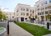Thumbnail 47 of 78 - A modern courtyard surrounded by apartment buildings.