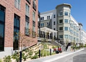 Thumbnail 38 of 78 - A row of modern buildings with a clear blue sky above them.