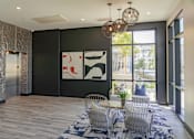 Thumbnail 34 of 78 - A modern living room with a large abstract painting on the wall.