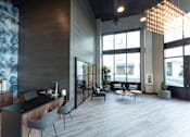 Thumbnail 29 of 78 - A modern office space with a reception desk and comfortable seating areas.