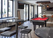 Thumbnail 15 of 78 - A room with a pool table and a television.