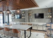 Thumbnail 10 of 78 - A modern dining area with a long table and chairs.