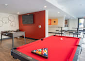 Thumbnail 8 of 78 - A pool table with a red cloth and a set of balls on it.
