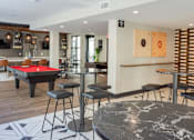 Thumbnail 7 of 78 - A room with a pool table and bar stools.