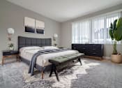 Thumbnail 1 of 14 - A bedroom with a large bed and a bench at The Pier at Sausalito, Sausalito, CA