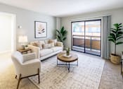 Thumbnail 1 of 10 - A living room with a white sofa, a white armchair, a coffee table, and a large window with a view of the outside.