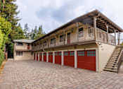 Thumbnail 10 of 10 - the carriage house has a large garage with red doors