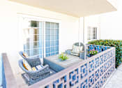 Thumbnail 5 of 9 - A patio with a table and chairs.
