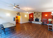 Thumbnail 9 of 10 - A living room with a fireplace and a dining table.