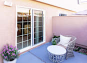 Thumbnail 7 of 11 - A patio with a chair and table.