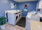 Thumbnail 9 of 11 - A laundromat with washers and dryers.