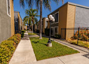 Thumbnail 6 of 7 - A row of houses with a sidewalk and a lamp post.