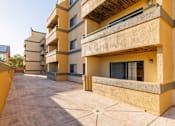 Thumbnail 6 of 9 - A sunny day at a courtyard surrounded by buildings.