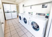Thumbnail 8 of 9 - A row of washing machines in a laundromat.