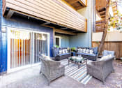 Thumbnail 4 of 9 - A patio with a table and chairs.