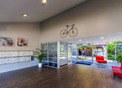 Thumbnail 8 of 10 - the preserve at cardinal woods lobby with red chairs and a bicycle hanging from the ceiling