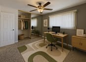 Thumbnail 3 of 11 - A room with a desk, chair, and a ceiling fan.