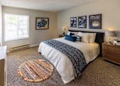 Thumbnail 4 of 8 - A bedroom with a large bed and a carpeted floor.
