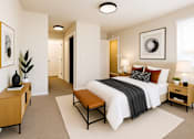 Thumbnail 6 of 12 - A bedroom with a large bed, a nightstand, and a bench.