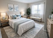 Thumbnail 5 of 12 - A bedroom with a large bed, a bench, and a window.