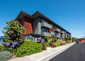 Thumbnail 7 of 9 - a modern apartment building with a street in front of it