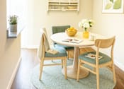 Thumbnail 2 of 9 - A dining room with a table set for two.