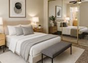 Thumbnail 5 of 14 - A bedroom with a large bed, a bench, and a mirror.