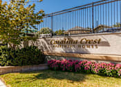 Thumbnail 1 of 9 - A sign that says "Carmelita Crest Apartment Homes" is on a wall.