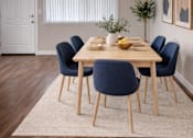 Thumbnail 3 of 14 - A dining room with a table set for six.