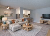 Thumbnail 1 of 14 - A living room with a grey couch, a wooden coffee table, and a television.