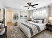 Thumbnail 2 of 7 - A bedroom with a large bed and a ceiling fan.