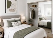 Thumbnail 1 of 9 - A bedroom with a large bed and a mirrored closet door.