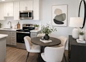 Thumbnail 1 of 14 - A modern kitchen with a dining table set for two.
