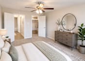 Thumbnail 5 of 14 - A living room with a white couch and a grey dresser.