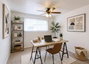 Thumbnail 3 of 9 - A room with a desk, chair, and a ceiling fan.