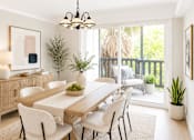 Thumbnail 2 of 14 - A dining room with a wooden table and chairs.