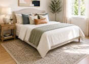 Thumbnail 3 of 14 - A bed with a white comforter and a grey blanket is in the center of the image.