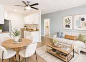 Thumbnail 1 of 10 - A modern living room with a dining table and chairs.