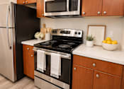 Thumbnail 2 of 9 - A black stove top oven with a white towel on it.