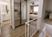 Thumbnail 5 of 11 - A white bathroom with a mirror and a white bedroom with a bed.