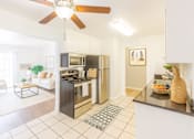 Thumbnail 3 of 12 - A modern kitchen with a black fridge and stove.