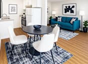 Thumbnail 4 of 8 - A modern dining room with a black table and white chairs.