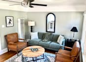 Thumbnail 1 of 10 - a living room with a couch and a coffee table